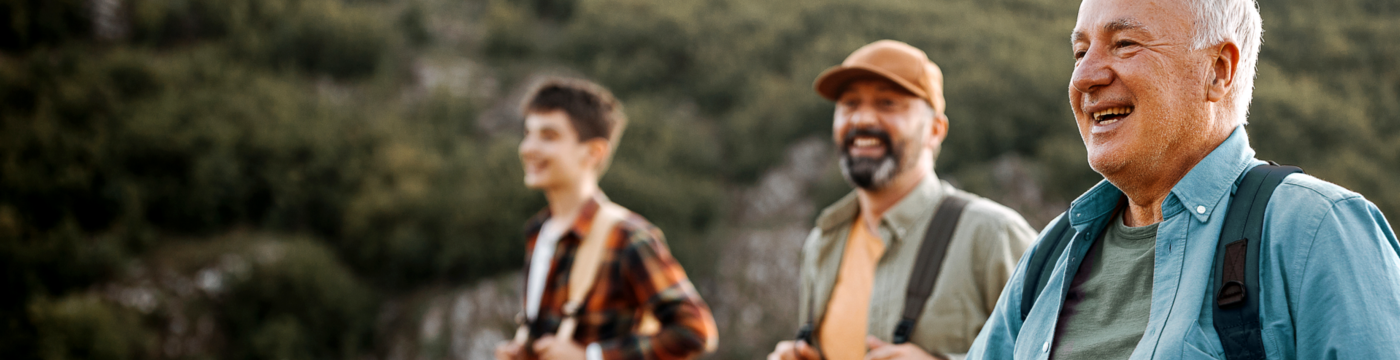 A man in a blue polo, hiking with his friends