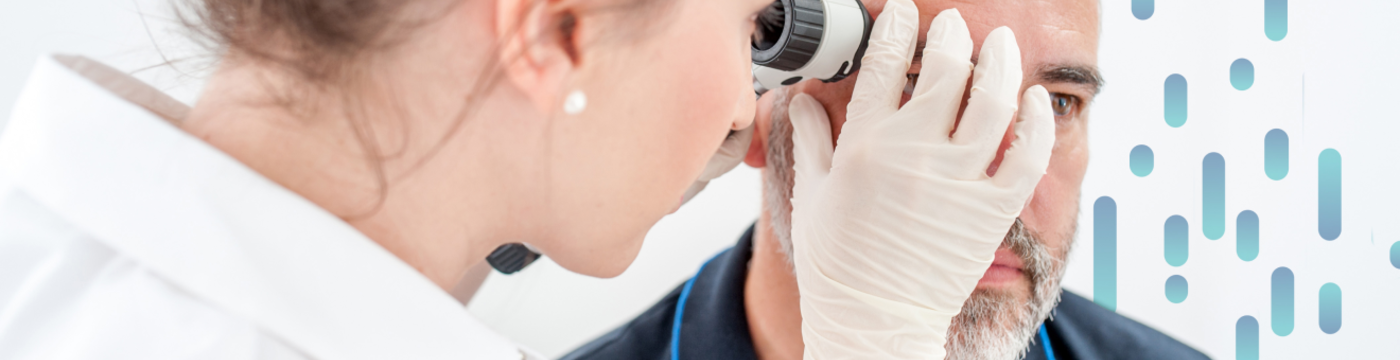 A physician uses a dermatoscope to inspect a skin lesion on a patient's forehead