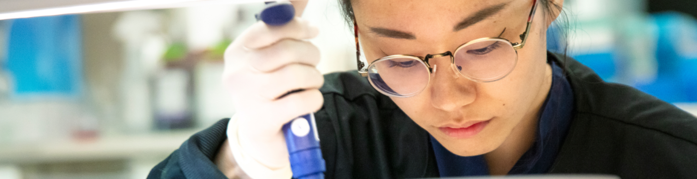 A lab technician handles a micropipette